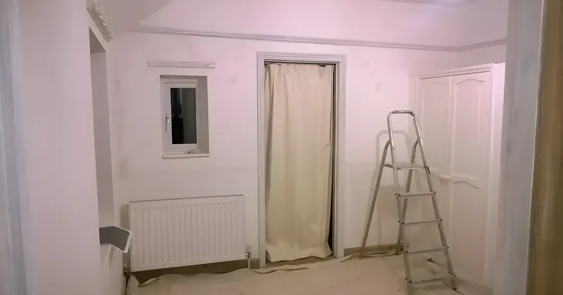 Histon bedroom mid-decoration with masked floor, stepladder and newly painted pale walls