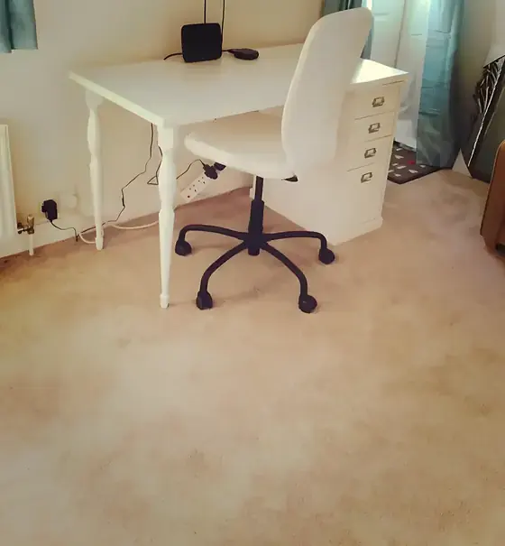 Desk area in the Cambridge studio flat with a white desk, office chair and cream carpet against freshly painted walls