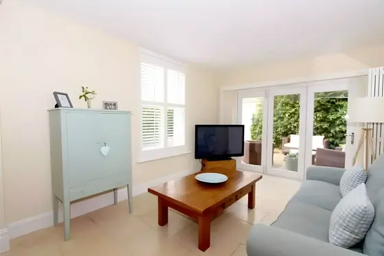 Bright living room with pale grey walls and white woodwork, decorated by Graham Halpenny