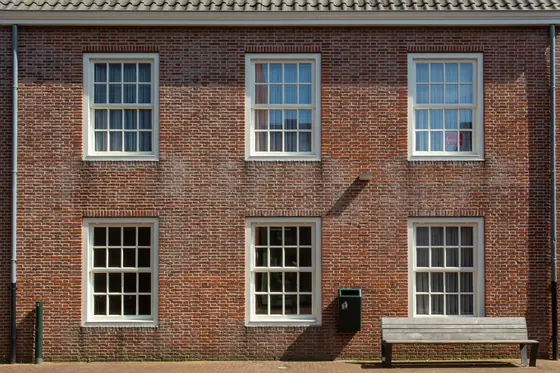 Georgian red-brick house front with white painted sash windows