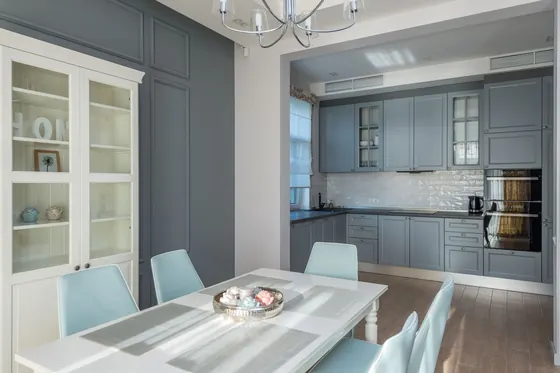 Grey Shaker-style kitchen units beyond a dining table