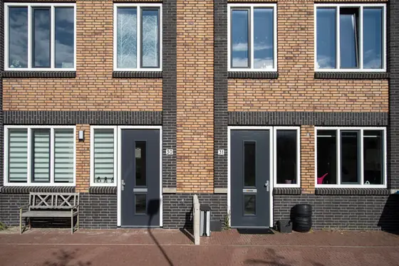Brick terraced houses with anthracite grey window frames and front doors